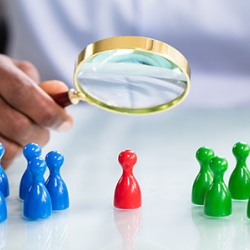reviewing new person in the middle with magnifying glass